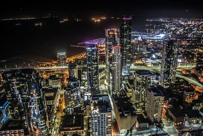 High angle view of city lit up at night