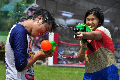 Children playing with water guns at yard