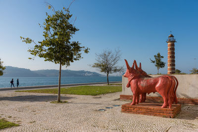Horse statue on beach against sky