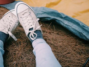 Low section of woman wearing canvas shoes