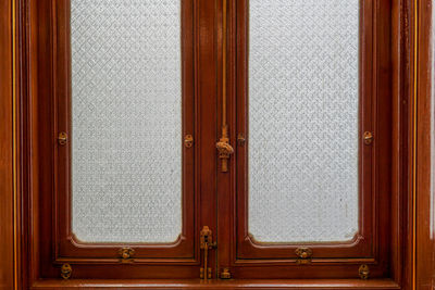 Vintage wooden window with gold iron locked bolt