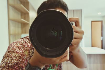 Close-up of man photographing at home