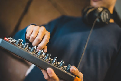 Close-up of man playing guitar