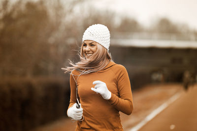 Woman wearing hat standing outdoors