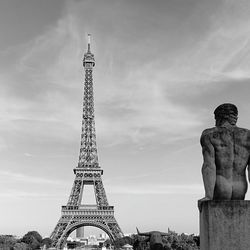 Low angle view of statue of tower against cloudy sky