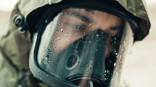 Man with gas mask under the rain