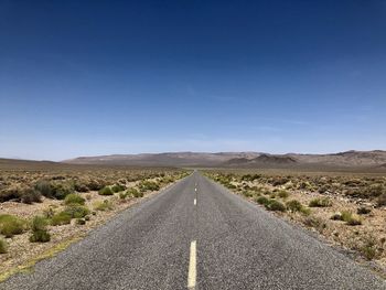 Road passing through landscape against sky