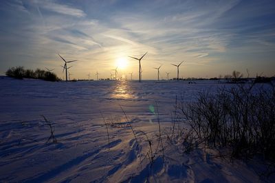 Scenic view of snowy landscape against sky during sunset