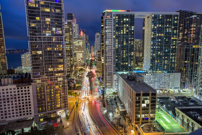 Aerial view of illuminated buildings in city at night