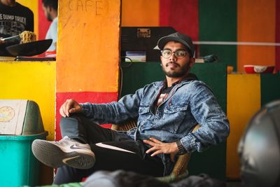 Young man sitting on chair