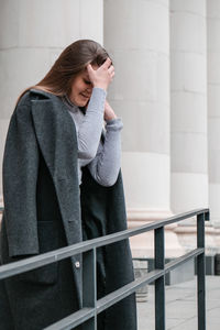 Portrait of young smiling caucasian brunette woman. businesswoman outdoors in business downtown. 