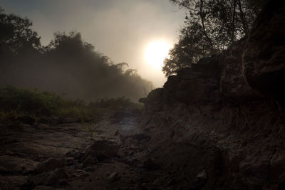 Rock formation on land against sky during sunset