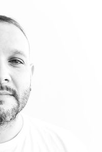 Close-up portrait of man against white background