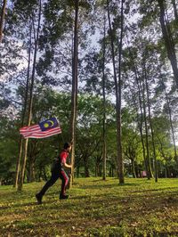 Full length of woman on field in forest