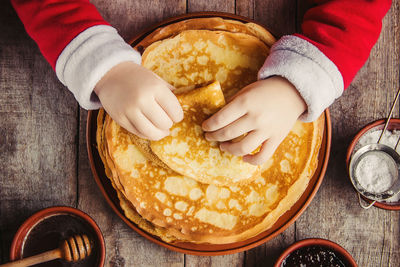 Cropped hand of person preparing food