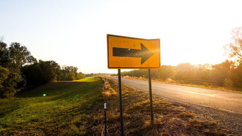 Information sign on road against sky