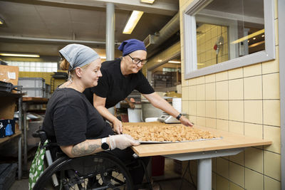 Disabled woman working in food factory