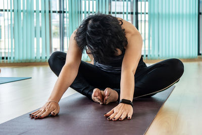 Young woman sitting on floor