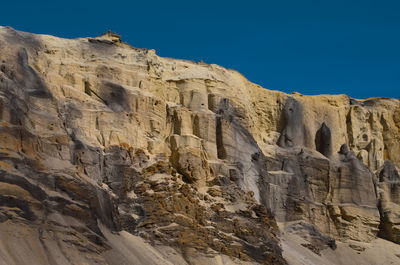 Low angle view of rock formations against sky