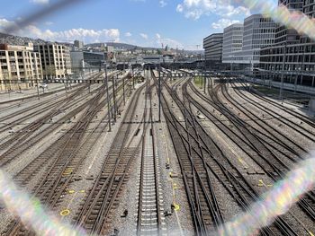 High angle view of railroad tracks in city against sky