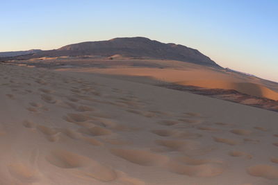 Scenic view of desert against clear sky