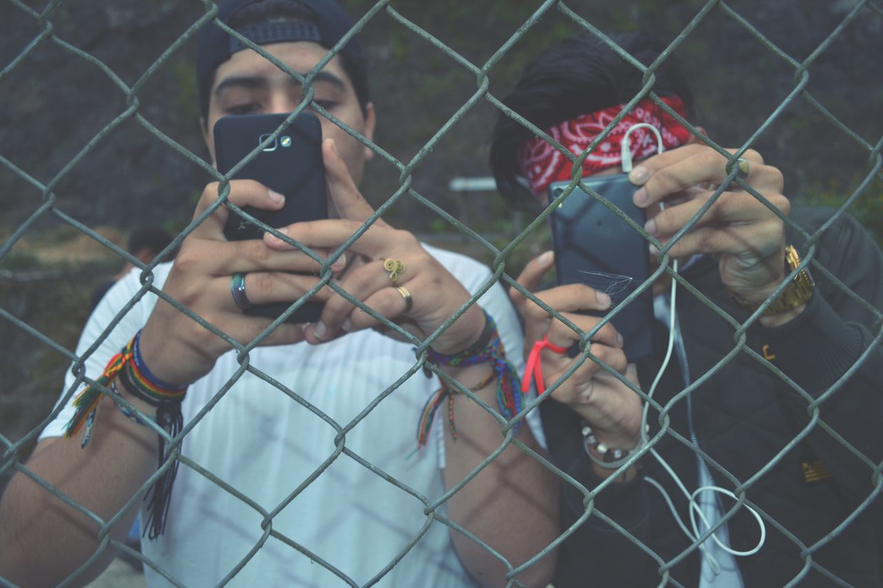 chainlink fence, fence, protection, safety, chainlink, security, metal, day, outdoors, togetherness, real people, close-up, human hand, people