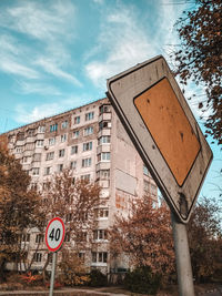 Road sign against built structures