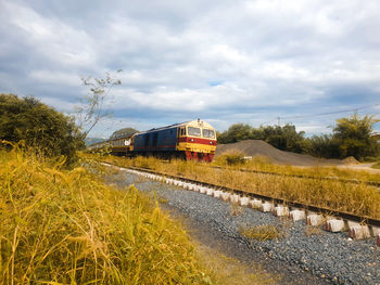 Train on railroad track against sky