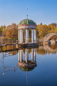Gazebo in the middle of the lake on a sunny autumn evening in the village of ivanki, ukraine