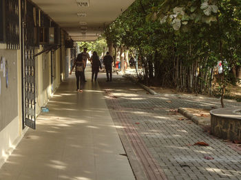 People walking on footpath in city