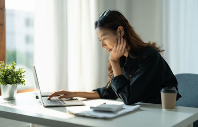 Businesswoman working at table