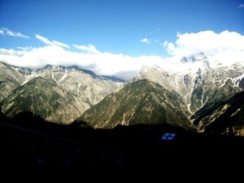 Scenic view of mountains against cloudy sky