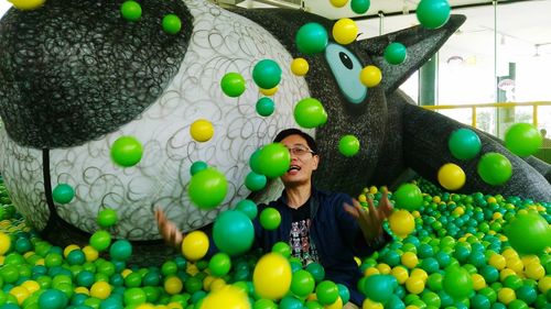 Portrait of a smiling young woman with colorful balloons