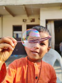 Portrait of boy holding bubbles