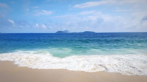 Scenic view of sea against cloudy sky