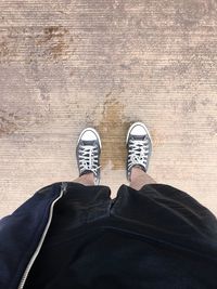 Low section of man standing on wet floor