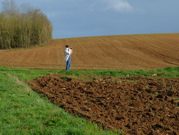 Full length of woman standing on field