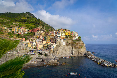 Aerial view of town by sea against sky