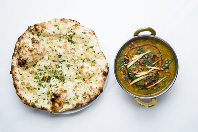 High angle view of pizza on table against white background