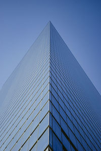 Low angle view of modern building against clear blue sky