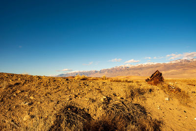 Scenic view of desert against blue sky