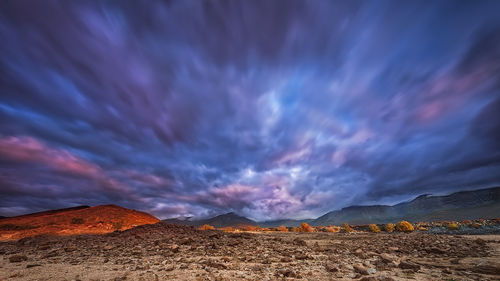 Scenic view of dramatic sky over land