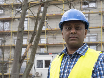 Portrait of young man standing in city