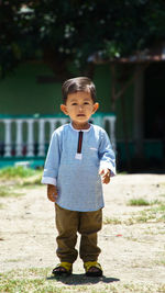 Portrait of cute boy standing outdoors