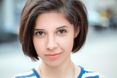 Close-up portrait of smiling young woman