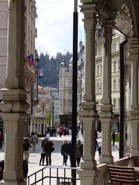 People on street amidst buildings in city