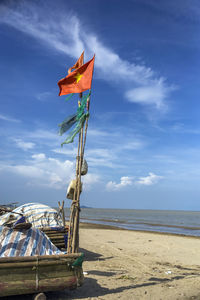 Lifeguard hut on beach against sky