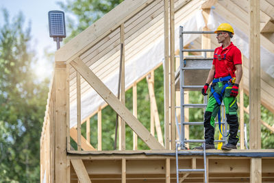 Full length of boy standing against building