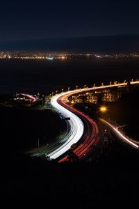 High angle view of light trails on road in city at night