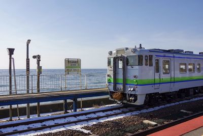 Clear blue sky, blue sea and old local train